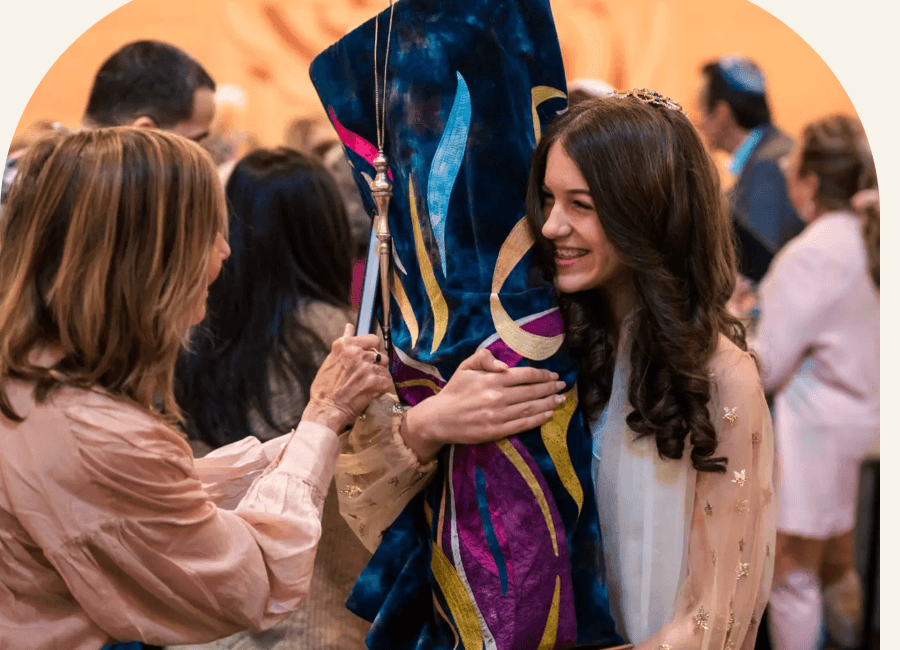 A young congregant reading from the Torah during her Bat Mitzvah at Sha'arei Shalom