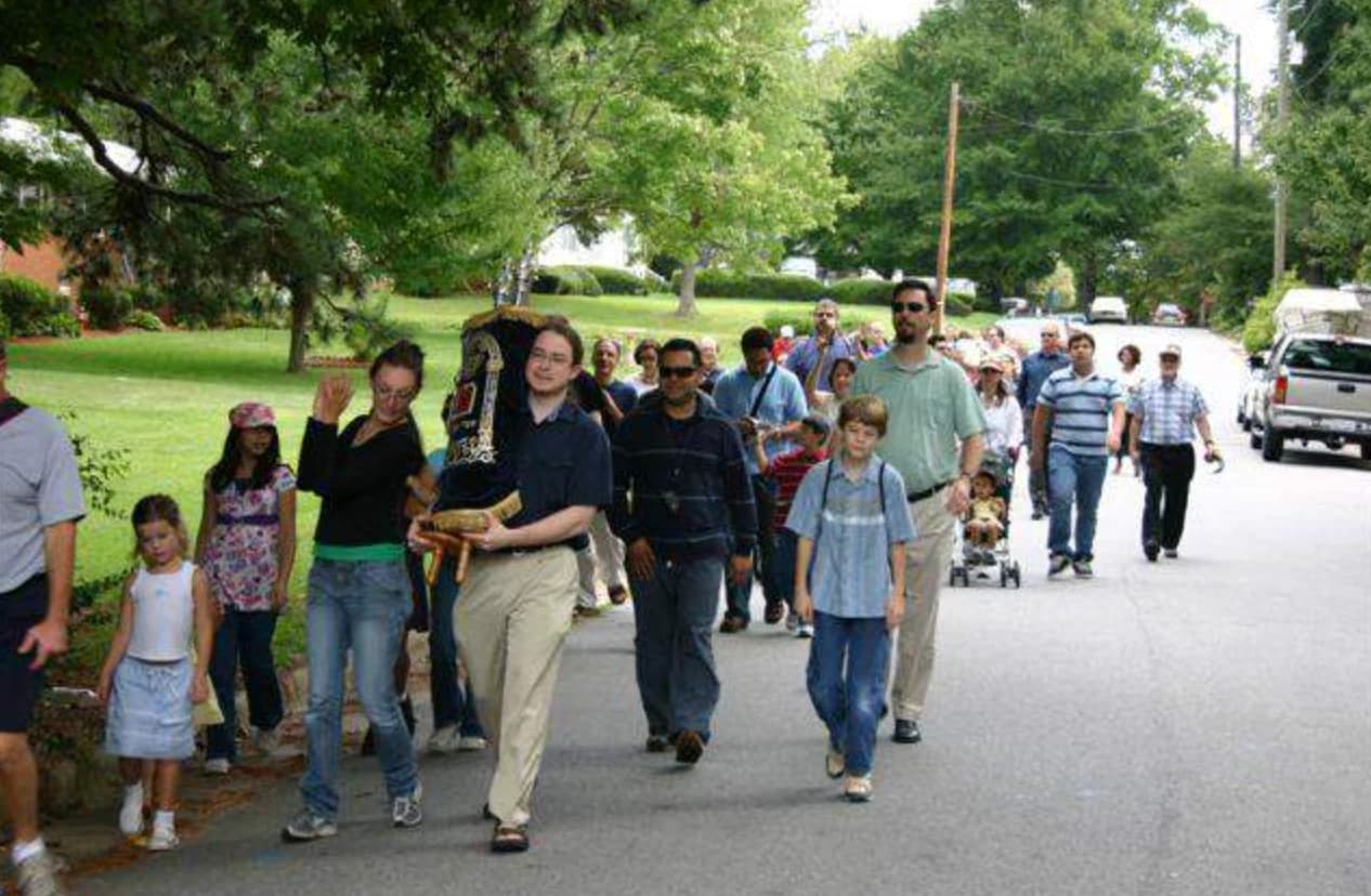 The congregation filling a Cary street during the 2008 Torah Walk, the scroll carried at the front
