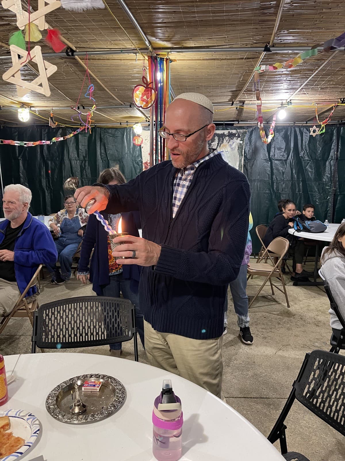 The havdalah candle lit inside the sukkah at Congregation Sha'arei Shalom in Cary, NC