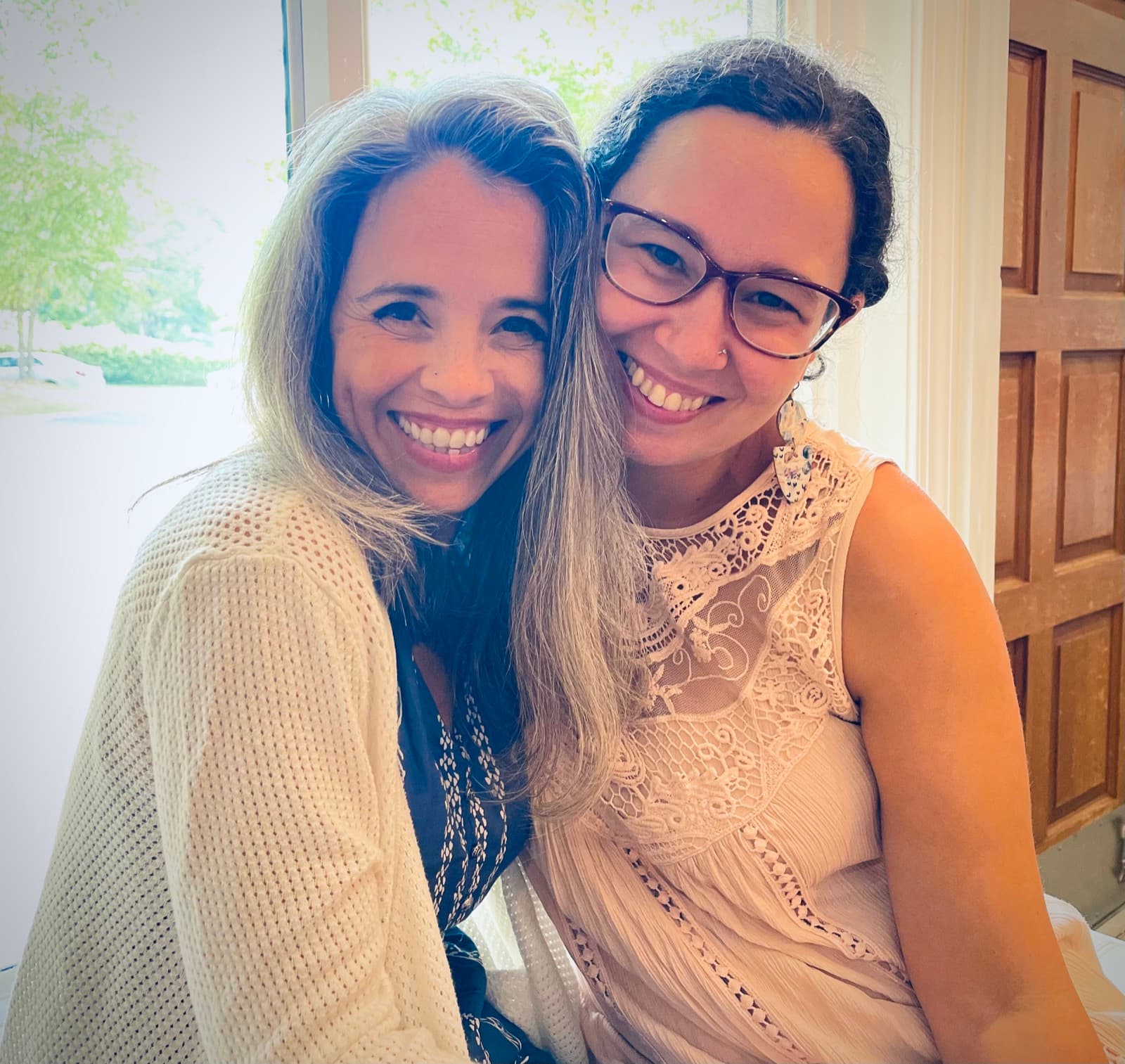 Two smiling Sisterhood women side by side at a congregational gathering