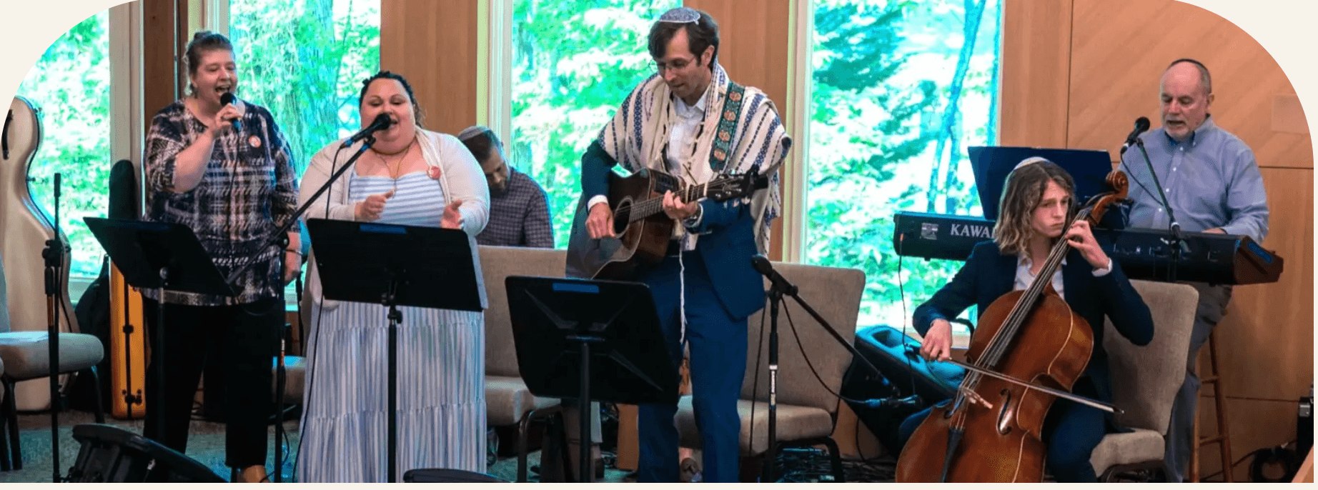 The Sha'arei Shalom worship team leading song, including young adult musicians on cello and guitar